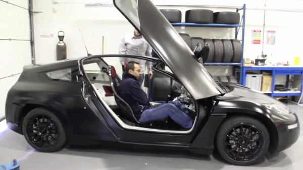 Delta E4 electric coupe goes out for a spin, carrying lucky humanoid Delta E4 electric coupe goes out for a spin, carrying lucky humanoid