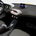 The interior is minimalist with black leather seats with yellow accents.